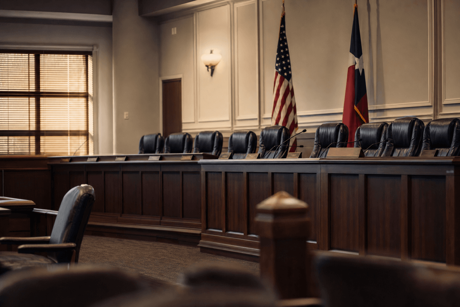 Empty Sherman City Council chambers with U.S. and Texas flags